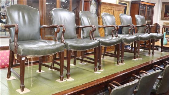 A set of twelve George III style mahogany elbow chairs, upholsterd in studded green leather